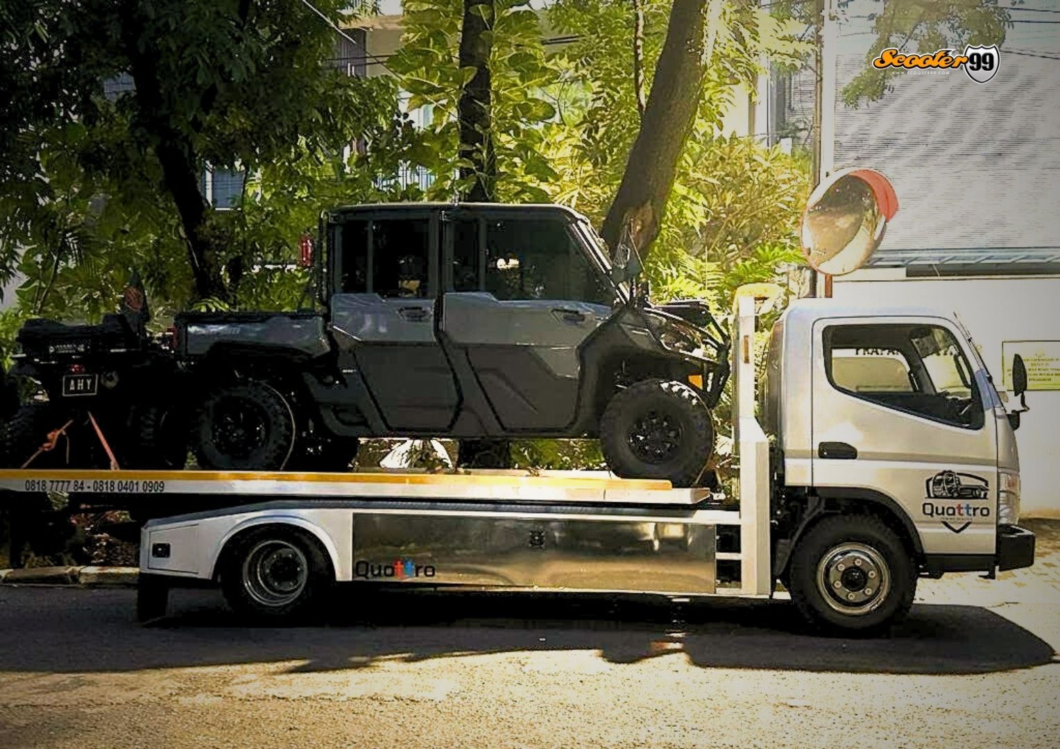 Professional flatbed towing of a car, showing careful handling